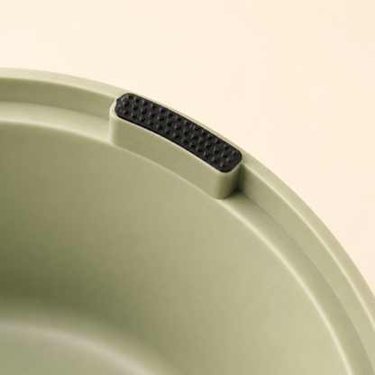 Close-up of the black textured anti-slip pad under the double bowl feeding station base